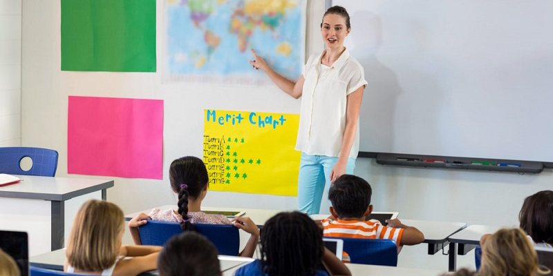 Young Female teacher teaching salish language in elementary class